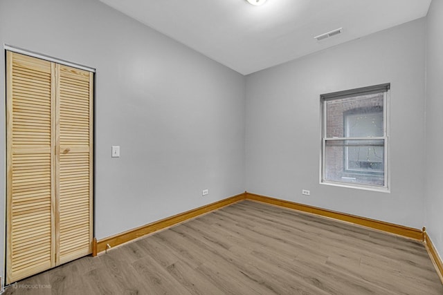 spare room featuring light wood-type flooring