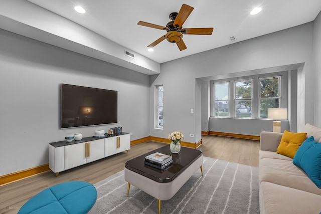 living room with ceiling fan and light wood-type flooring