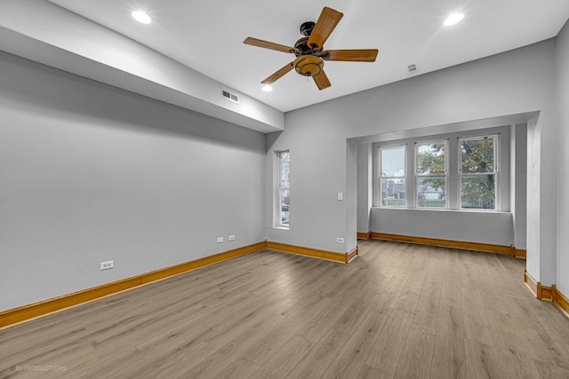 unfurnished living room featuring ceiling fan and light wood-type flooring