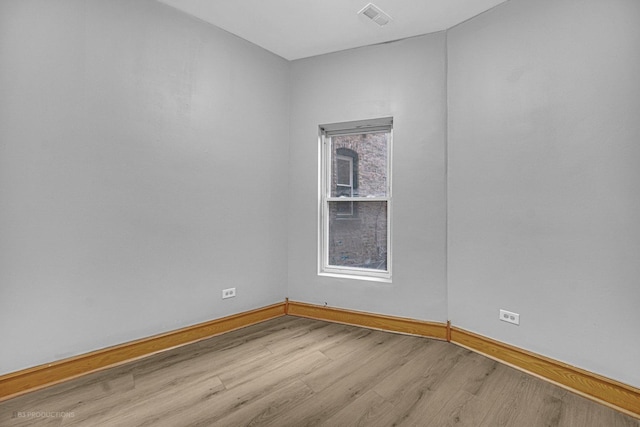 empty room with light hardwood / wood-style flooring