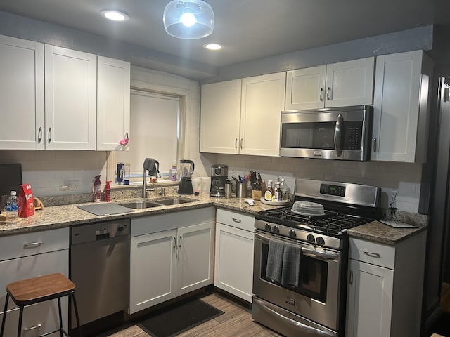 kitchen with white cabinetry, sink, and appliances with stainless steel finishes