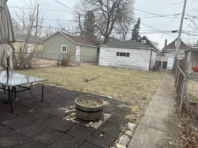 exterior space with a fire pit, an outdoor structure, and a patio area