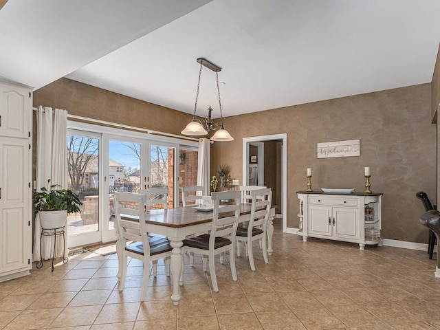 dining room with light tile patterned flooring and baseboards