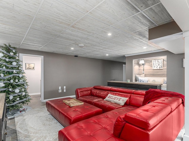 living room featuring baseboards, wood finished floors, and recessed lighting