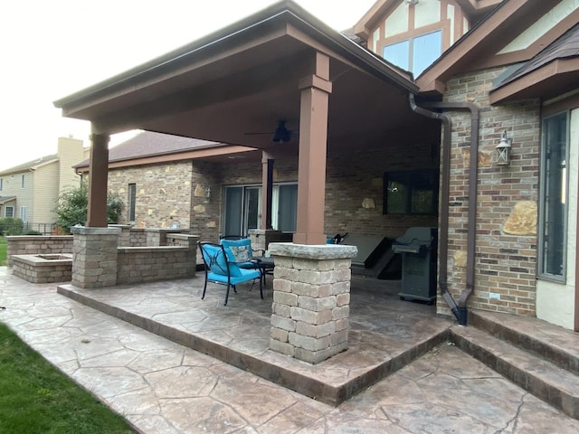 view of patio / terrace with ceiling fan, an outdoor kitchen, and area for grilling