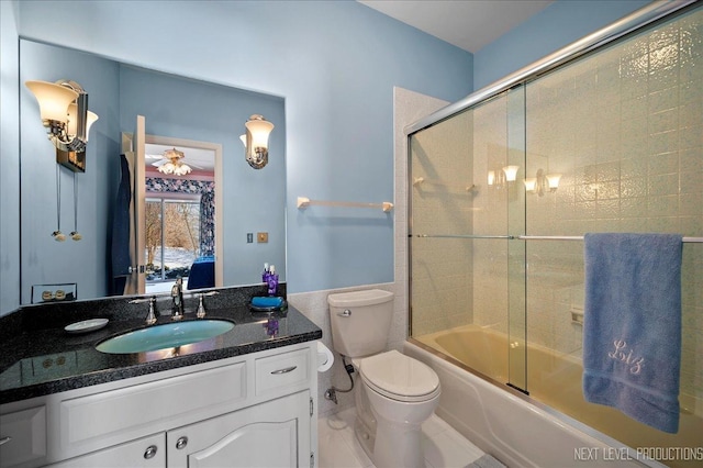 ensuite bathroom with shower / bath combination with glass door, vanity, toilet, and ensuite bathroom