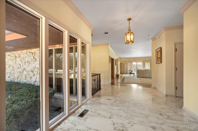 corridor featuring marble finish floor, visible vents, crown molding, and baseboards