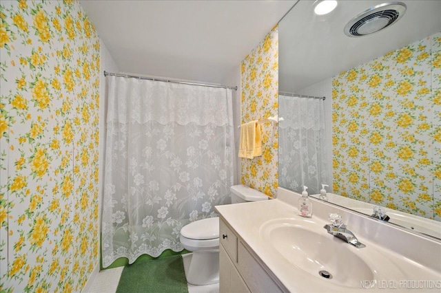 bathroom featuring visible vents, toilet, vanity, a shower with curtain, and wallpapered walls