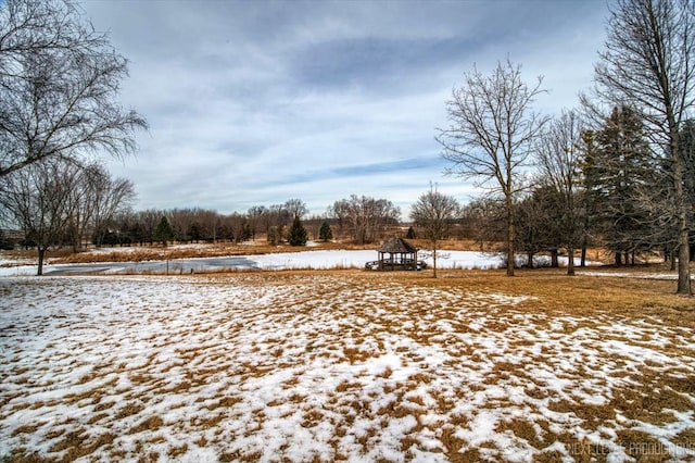 yard covered in snow with a gazebo