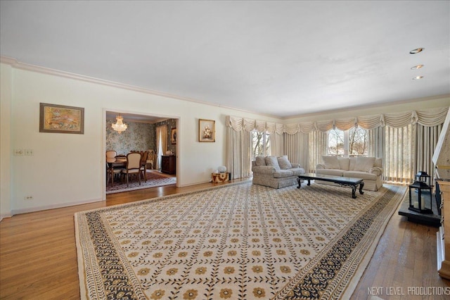 living room featuring ornamental molding, wood finished floors, and baseboards