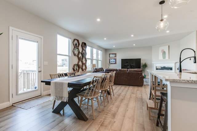 dining area featuring sink and light hardwood / wood-style flooring