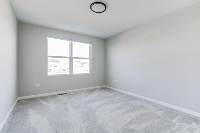 unfurnished room featuring light carpet