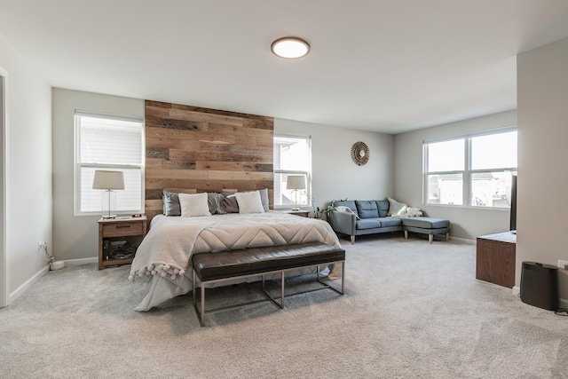 carpeted bedroom featuring wood walls