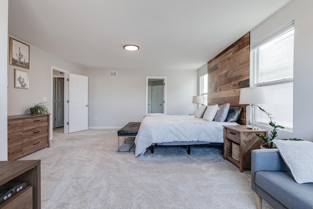 carpeted bedroom with wood walls