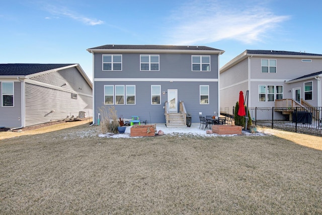 rear view of house with a yard and a patio