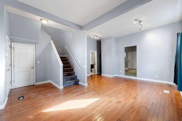 interior space with rail lighting and light wood-type flooring