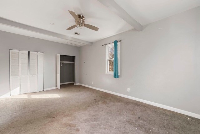 unfurnished bedroom with multiple closets, ceiling fan, light colored carpet, and beam ceiling