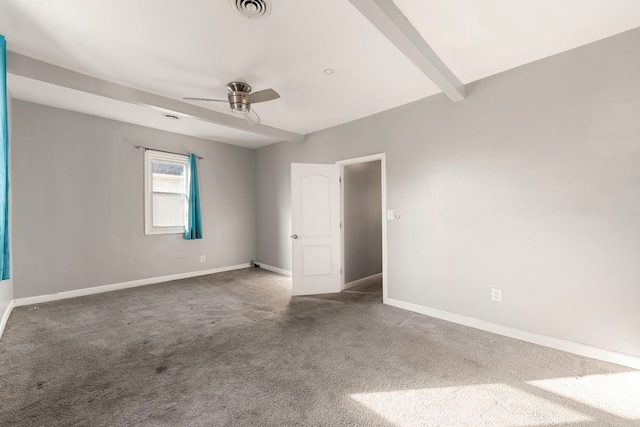 carpeted spare room with ceiling fan and beam ceiling