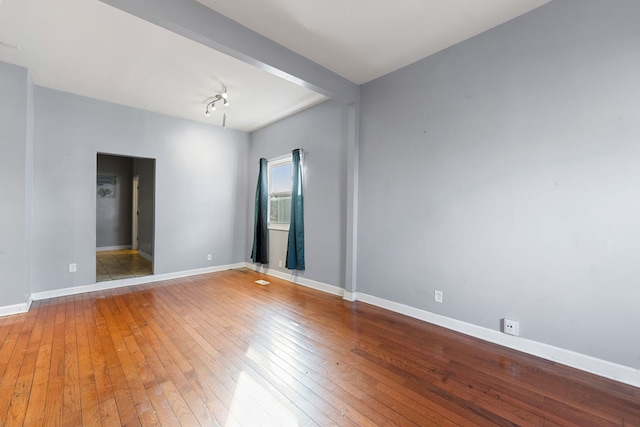 unfurnished room featuring hardwood / wood-style floors