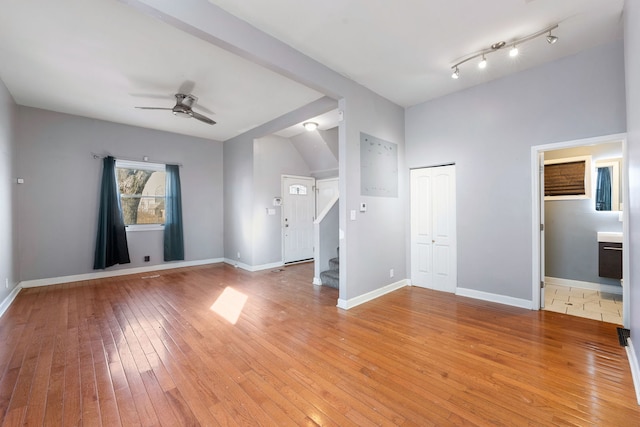 unfurnished living room with ceiling fan and light wood-type flooring