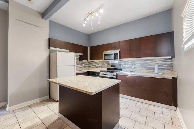 kitchen with light tile patterned flooring, decorative backsplash, a center island, stainless steel appliances, and dark brown cabinets