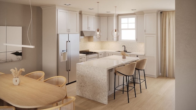kitchen featuring light stone counters, appliances with stainless steel finishes, sink, and white cabinets