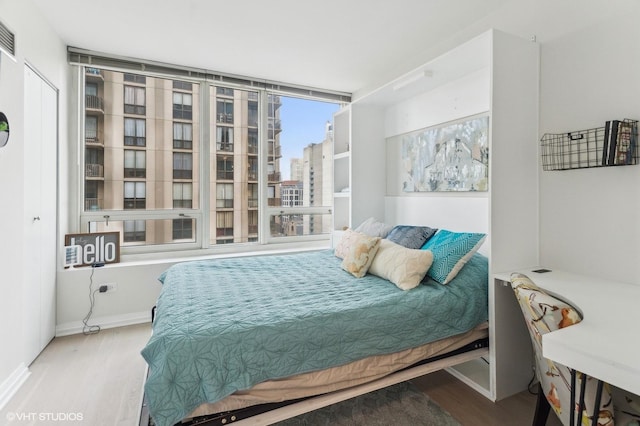 bedroom with hardwood / wood-style floors