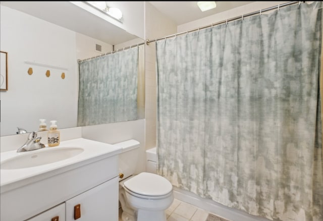 full bathroom with tile patterned flooring, vanity, shower / tub combo, and toilet