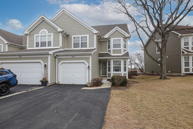 view of front facade with a garage and a front lawn