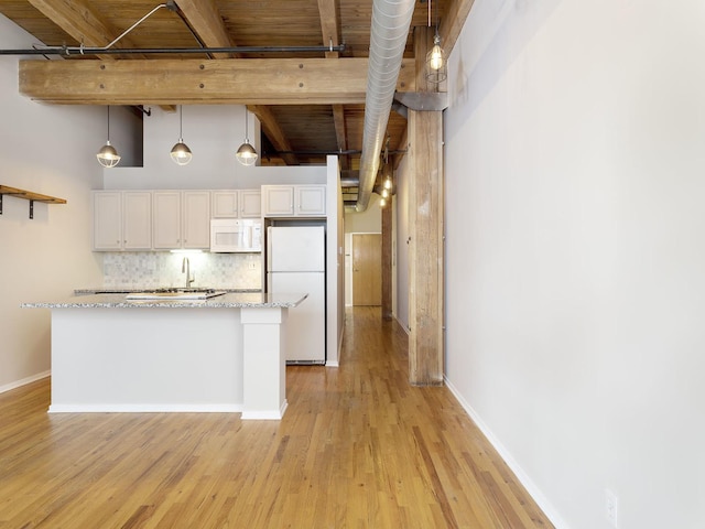 kitchen featuring white appliances, decorative light fixtures, light stone countertops, and white cabinets