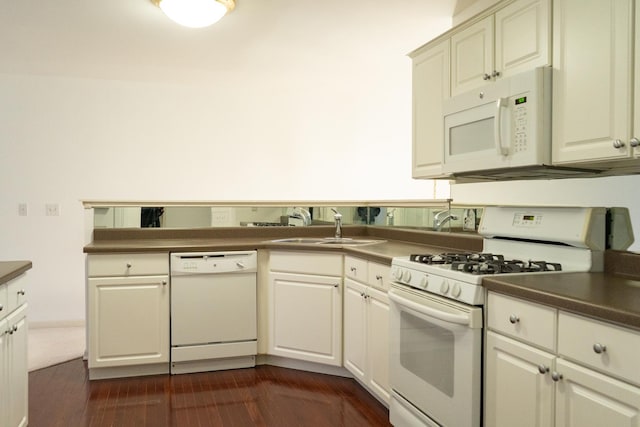 kitchen featuring sink, white appliances, and dark hardwood / wood-style floors