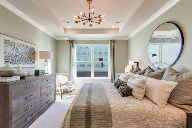 carpeted bedroom with a raised ceiling and a chandelier