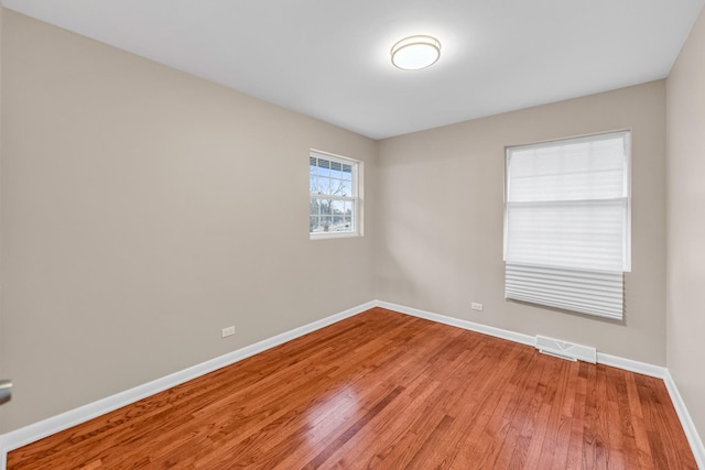 spare room with wood-type flooring