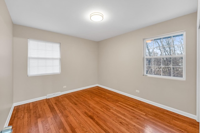 spare room featuring hardwood / wood-style flooring