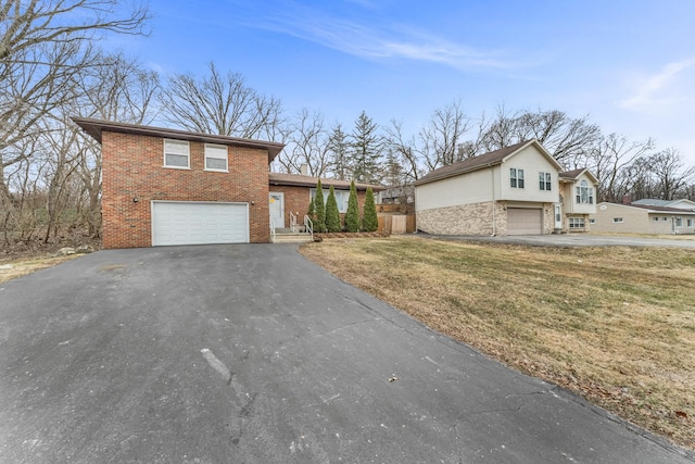 tri-level home with a garage and a front yard