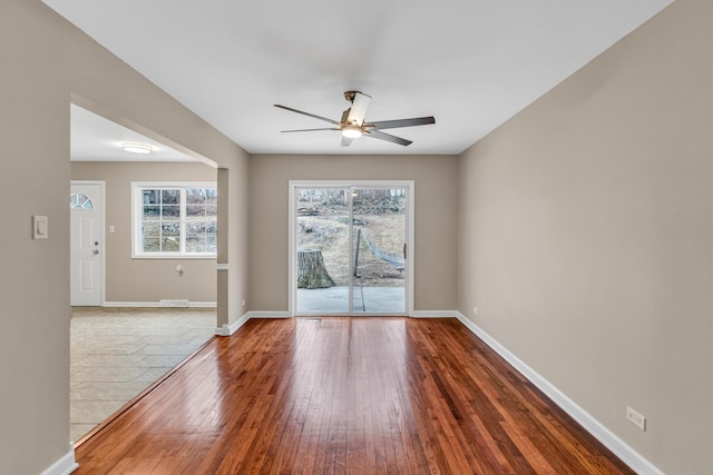 spare room with hardwood / wood-style flooring and ceiling fan