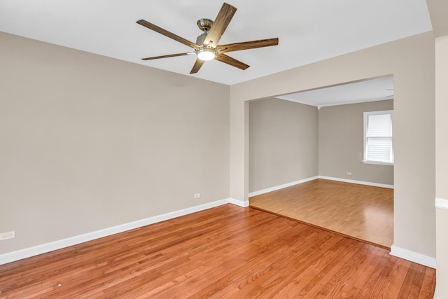 empty room with hardwood / wood-style floors and ceiling fan