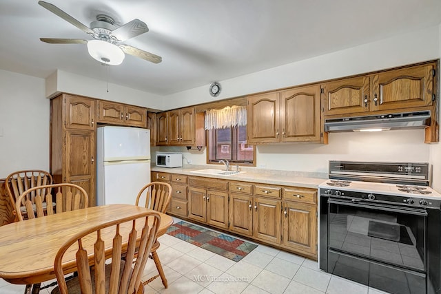 kitchen featuring ceiling fan, sink, light tile patterned floors, and white appliances