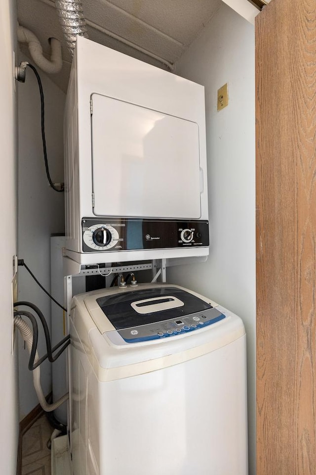 laundry area with stacked washing maching and dryer