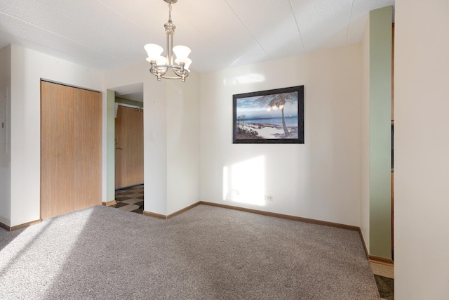 carpeted empty room with a chandelier