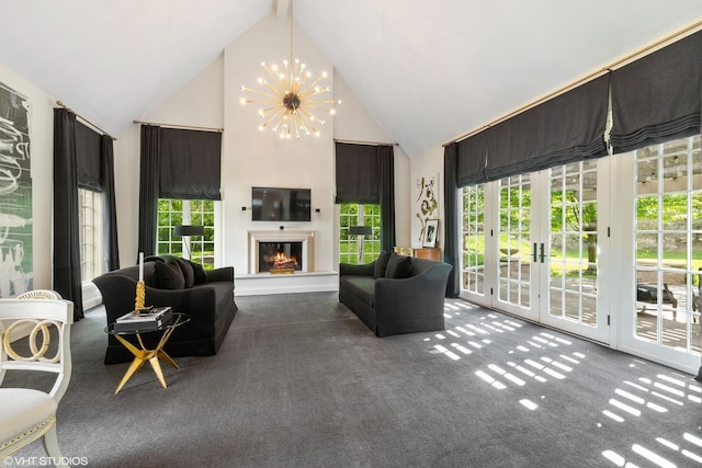 carpeted living room featuring french doors, plenty of natural light, a chandelier, and high vaulted ceiling