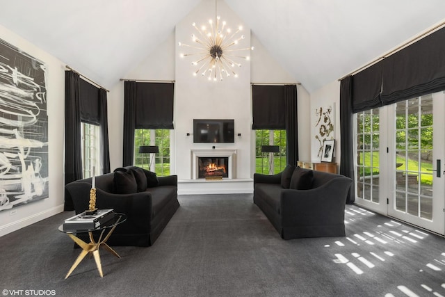 living room with dark colored carpet, high vaulted ceiling, and a chandelier