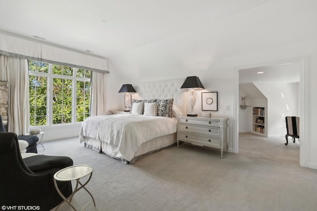 carpeted bedroom with vaulted ceiling