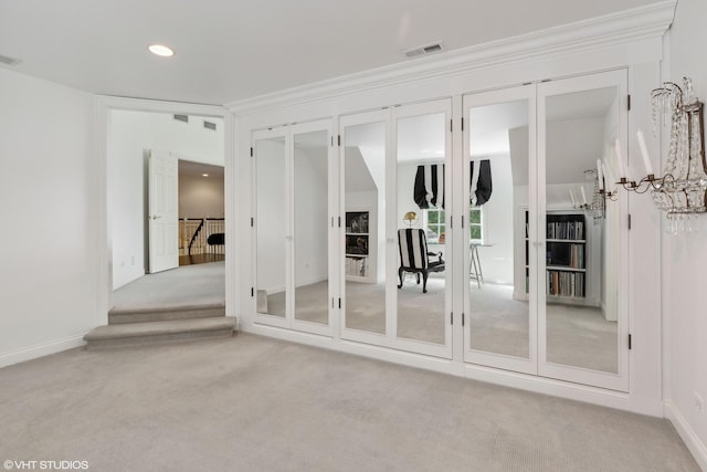 unfurnished room featuring light carpet and french doors