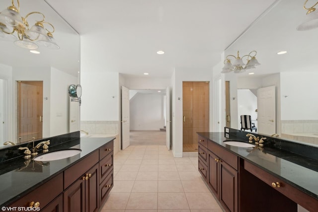 bathroom featuring tile patterned flooring, vanity, and walk in shower