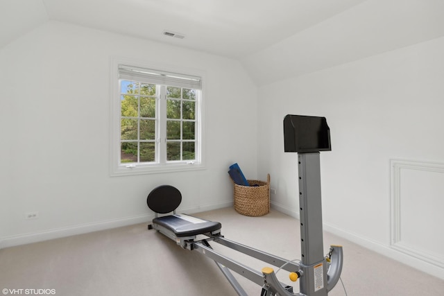 exercise area with carpet floors and vaulted ceiling