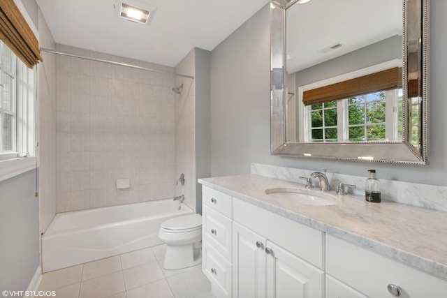 full bathroom with vanity, toilet, tiled shower / bath combo, and tile patterned flooring