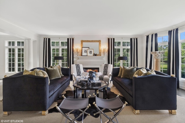 living room featuring ornate columns and crown molding