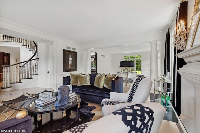 living room with ornate columns and crown molding