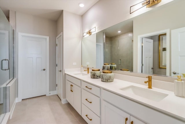 bathroom with vanity, a shower with shower door, and tile patterned floors